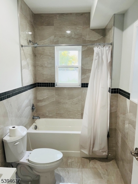 67 Wainwright Street, Unit 1 Newark, NJ 07112 - Photo 5 of 9 a bathroom with a toilet and a shower