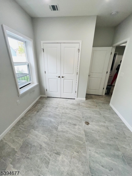 67 Wainwright Street, Unit 1 Newark, NJ 07112 - Photo 6 of 9 an empty room with windows