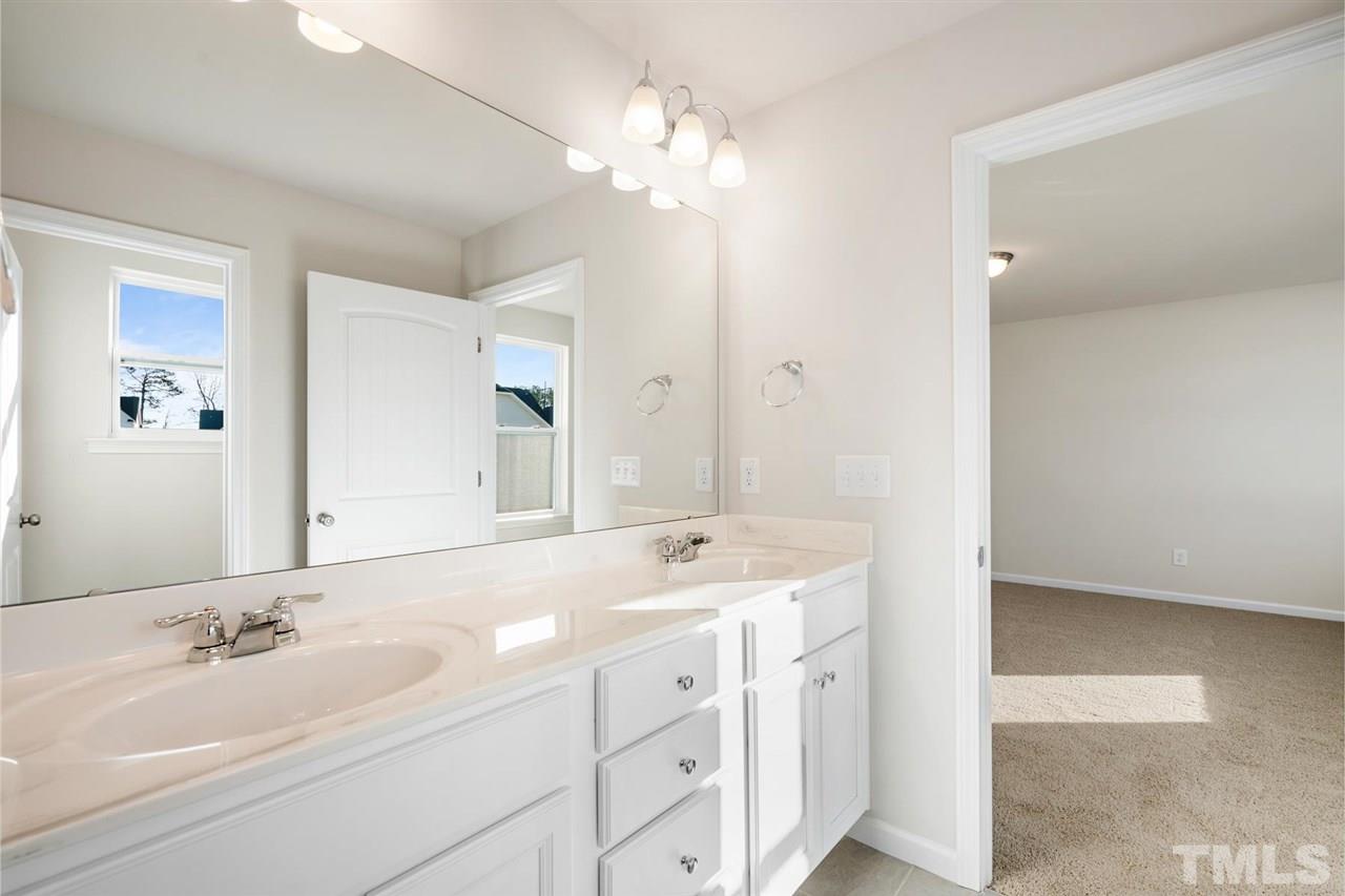 132 Scoville Road Garner, NC 27529 - Photo 11 of 26 a bathroom with a sink double vanity and a mirror