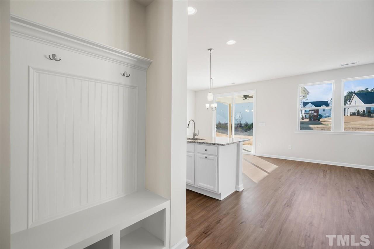 132 Scoville Road Garner, NC 27529 - Photo 16 of 26 a large white kitchen with wooden floor and a sink