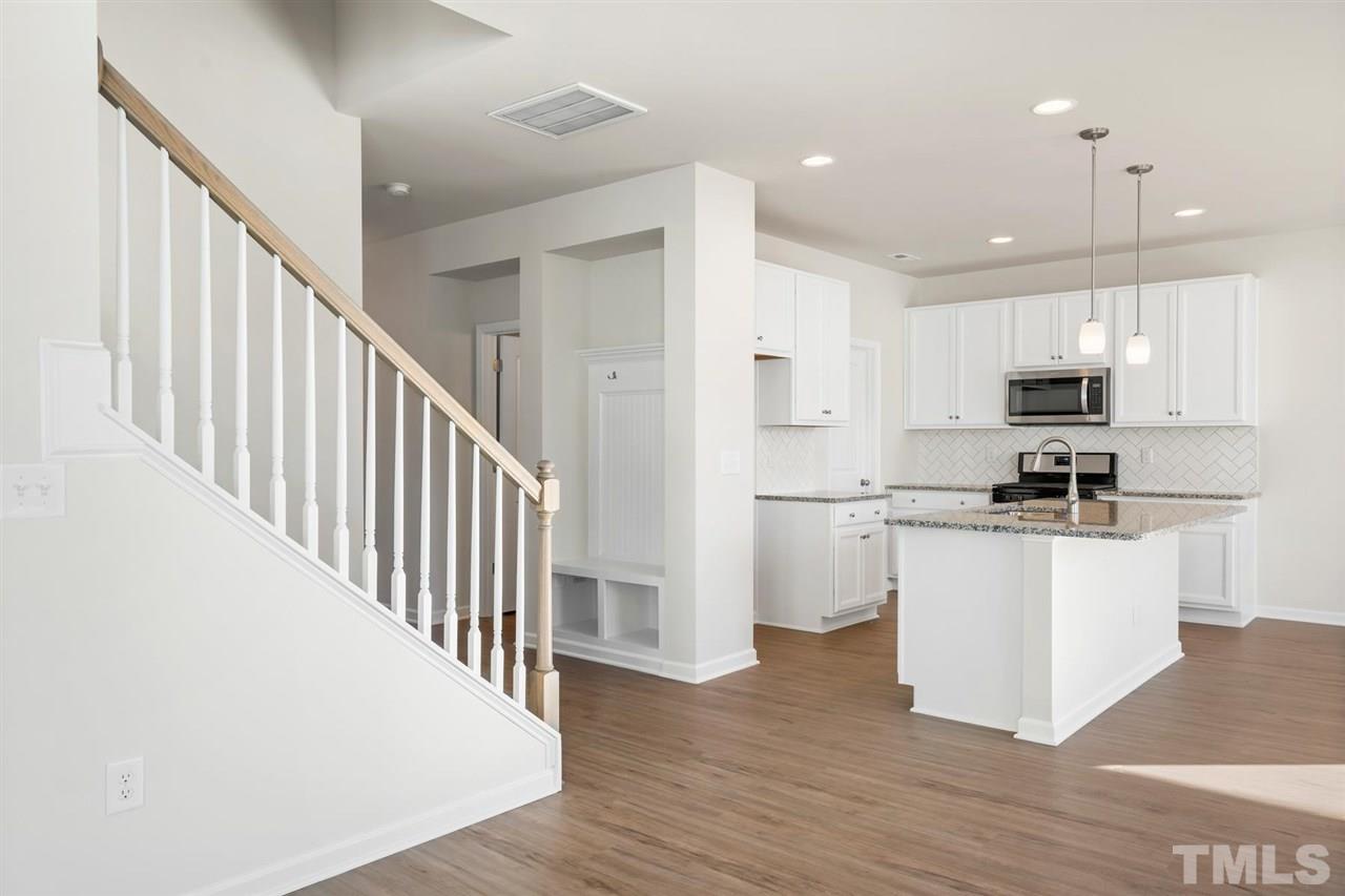 132 Scoville Road Garner, NC 27529 - Photo 17 of 26 a kitchen with white cabinets and stainless steel appliances
