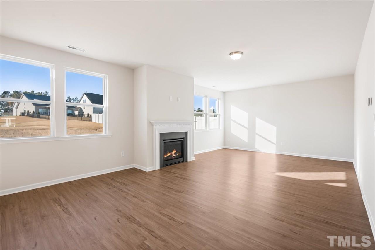 132 Scoville Road Garner, NC 27529 - Photo 20 of 26 a view of empty room with wooden floor and fireplace