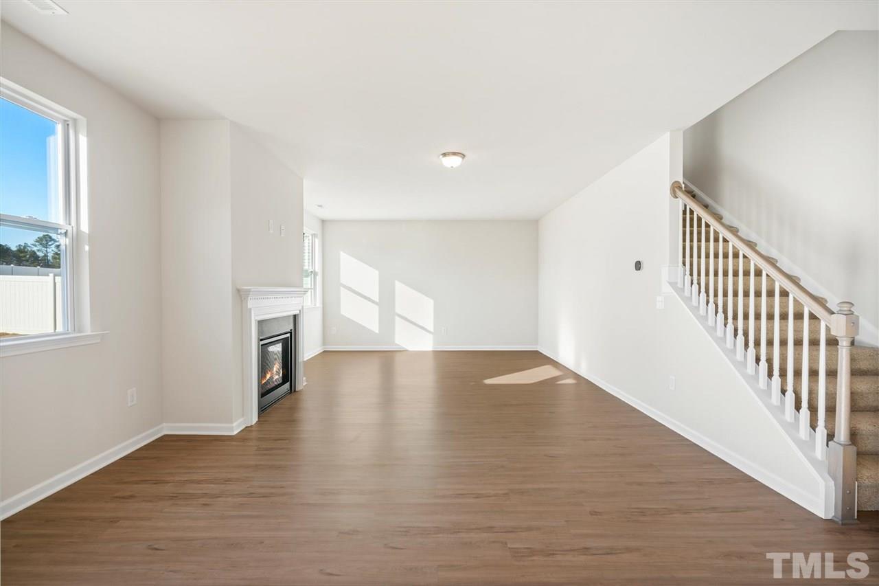 132 Scoville Road Garner, NC 27529 - Photo 21 of 26 a view of an empty room with wooden floor and a window