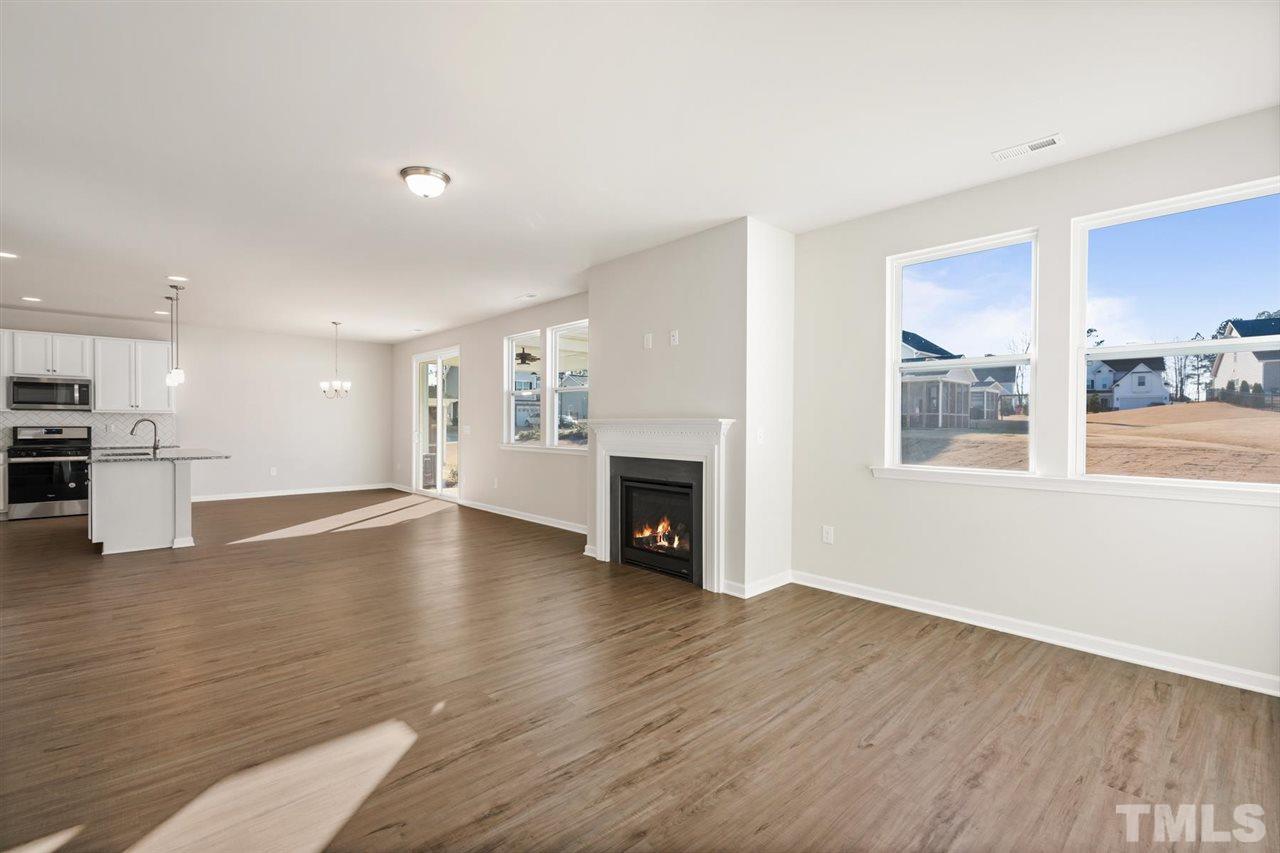 132 Scoville Road Garner, NC 27529 - Photo 24 of 26 a view of empty room with wooden floor and fireplace