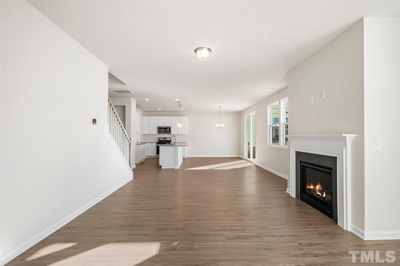 132 Scoville Road Garner, NC 27529 - Photo 25 of 26 a view of empty room with wooden floor and fireplace