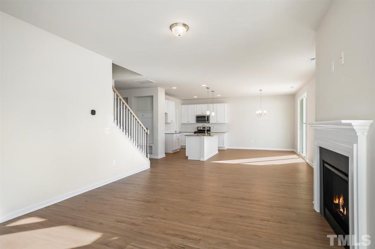132 Scoville Road Garner, NC 27529 - Photo 26 of 26 a view of kitchen and empty room with wooden floor