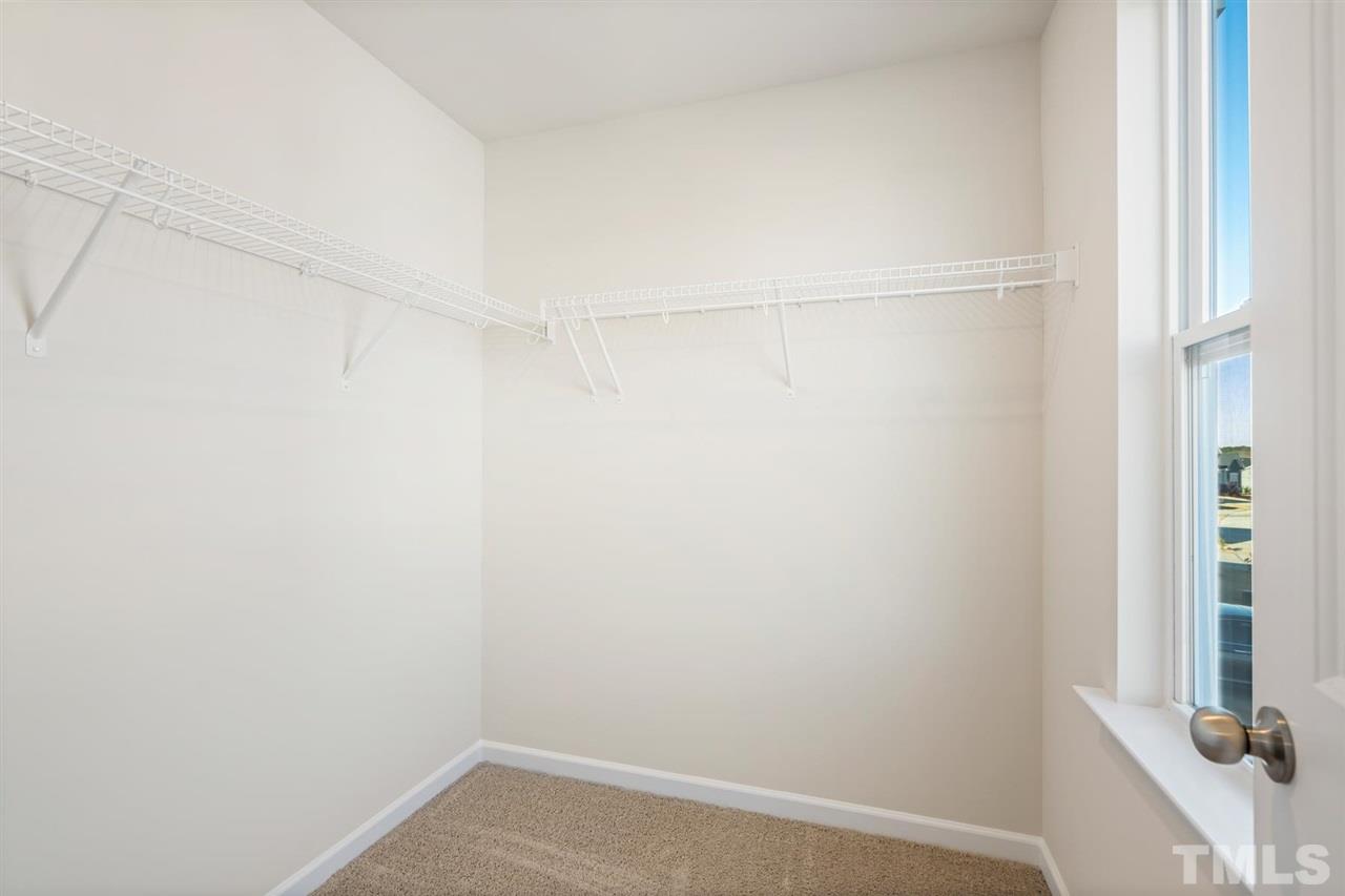 132 Scoville Road Garner, NC 27529 - Photo 6 of 26 a view of a room with racks on the wall