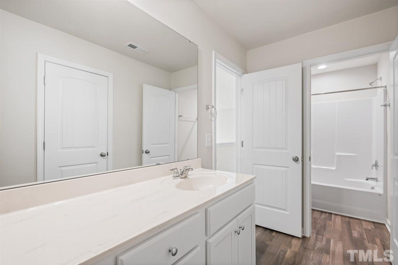 132 Scoville Road Garner, NC 27529 - Photo 8 of 26 a bathroom with a sink and a mirror