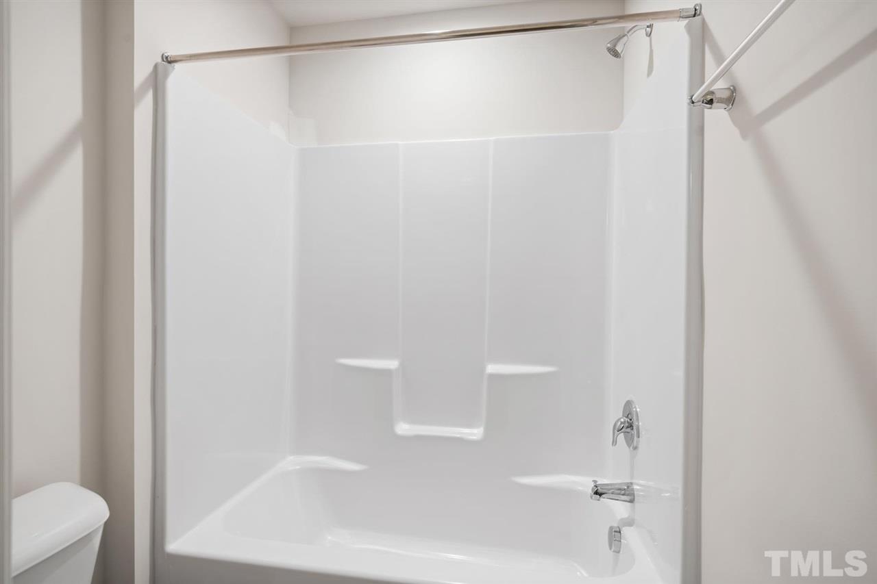 132 Scoville Road Garner, NC 27529 - Photo 9 of 26 a bathroom with a shower and a toilet