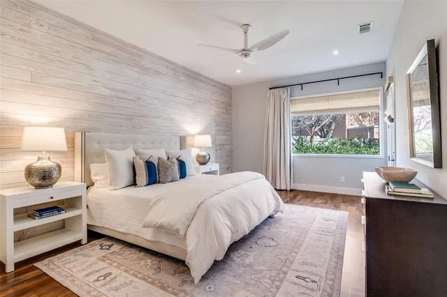 a bedroom with a large bed and a window