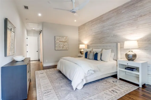 a bedroom with a large bed and chandelier