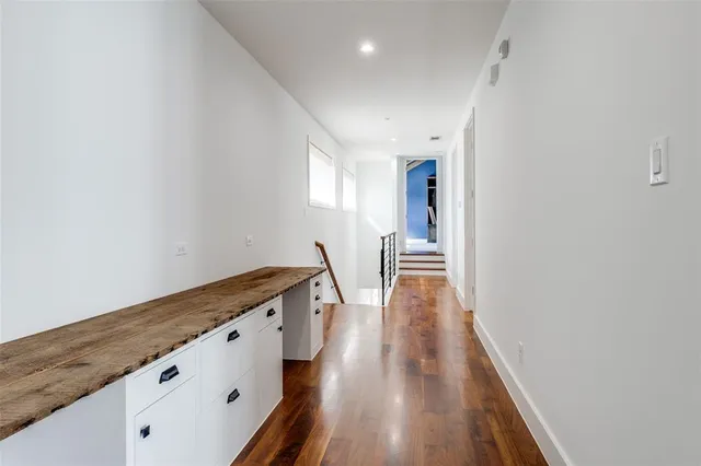 a view of a hallway with wooden floor