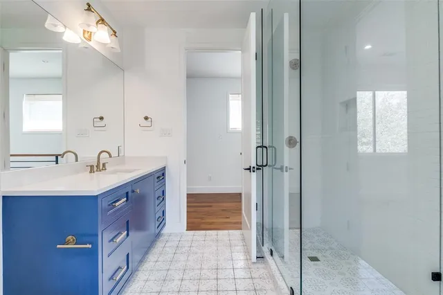 a bathroom with a sink a mirror and a shower