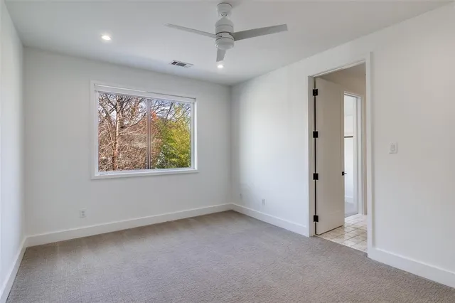 an empty room with windows and painted walls