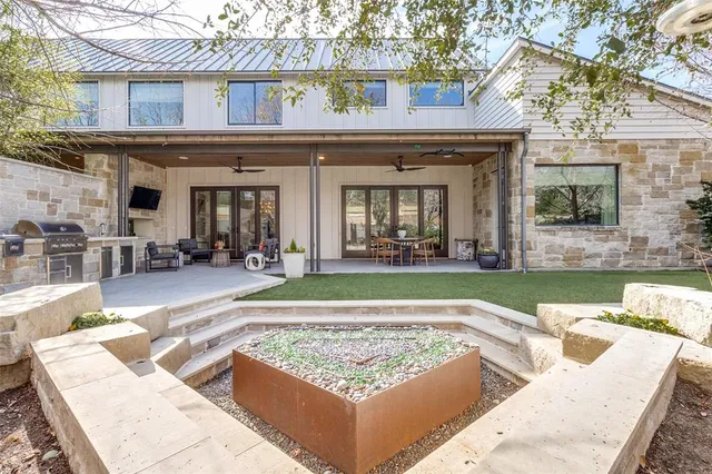 a view of a house with swimming pool and sitting area