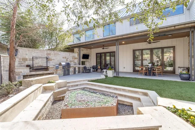 a view of a park with furniture and a garden