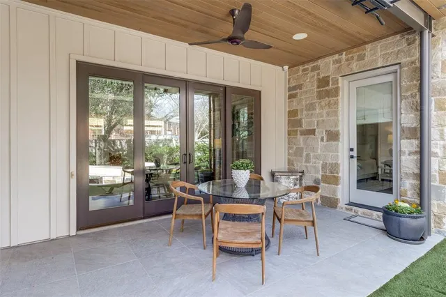 a room with lots of furniture and a potted plant