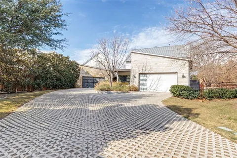 a view of a house with a yard and pathway