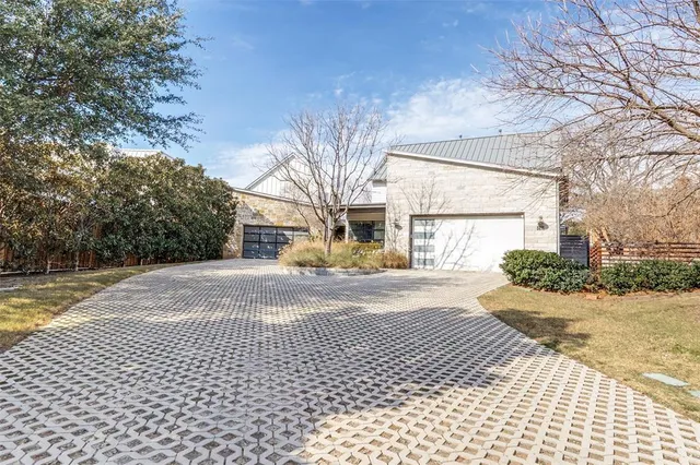 a view of a house with a yard and pathway