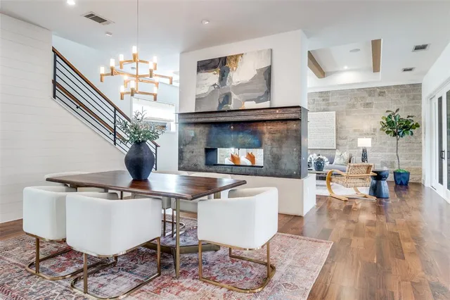 a living room with dining room and wooden floor