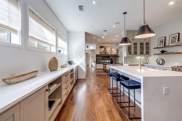 a kitchen with counter top space a sink appliances and cabinets