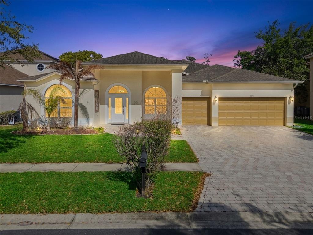 2541 Teton Stone Run Orlando, FL 32828 - Photo 1 of 82 a front view of a house with garden