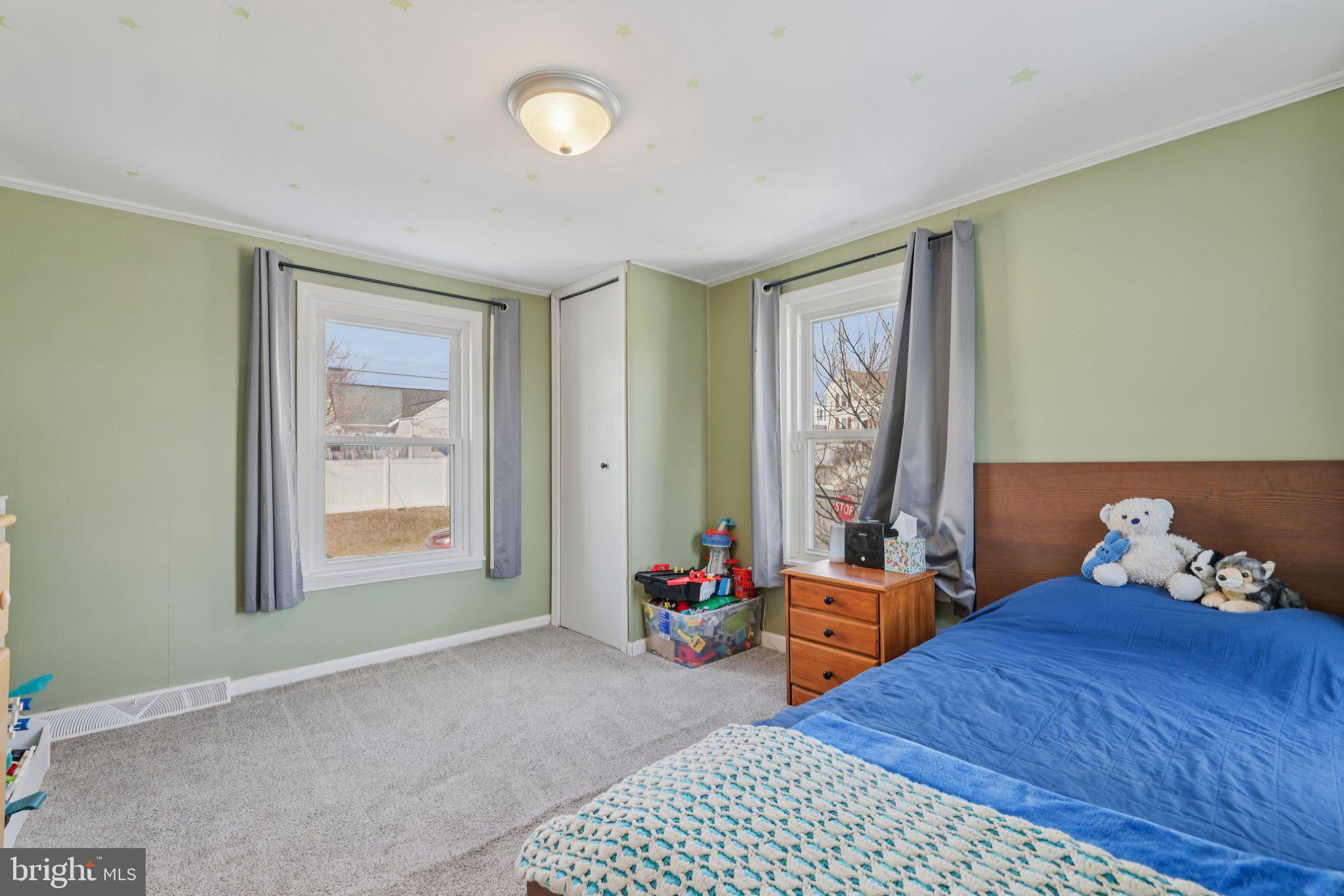 519 North Maple Avenue Brunswick, MD 21716 - Photo 19 of 26 a bedroom with a bed and wooden floor