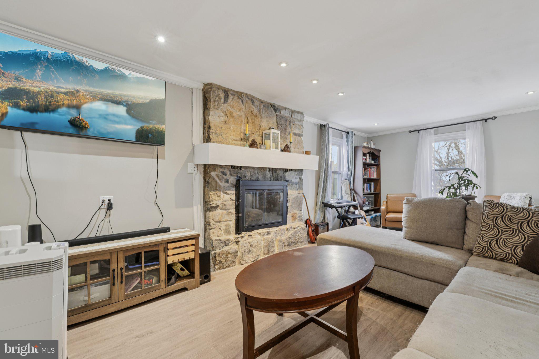 519 North Maple Avenue Brunswick, MD 21716 - Photo 5 of 26 a living room with furniture a flat screen tv and a fireplace