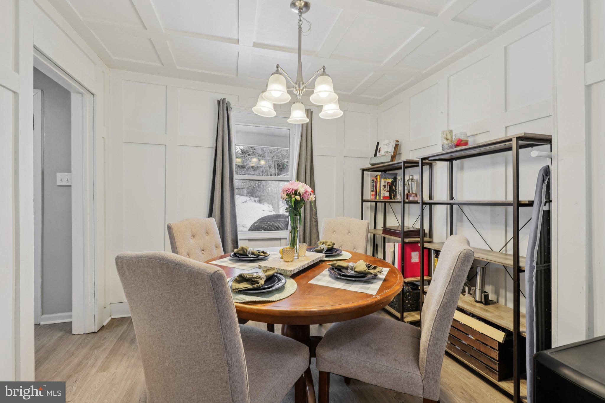519 North Maple Avenue Brunswick, MD 21716 - Photo 7 of 26 a view of a dining room with furniture a chandelier and wooden floor