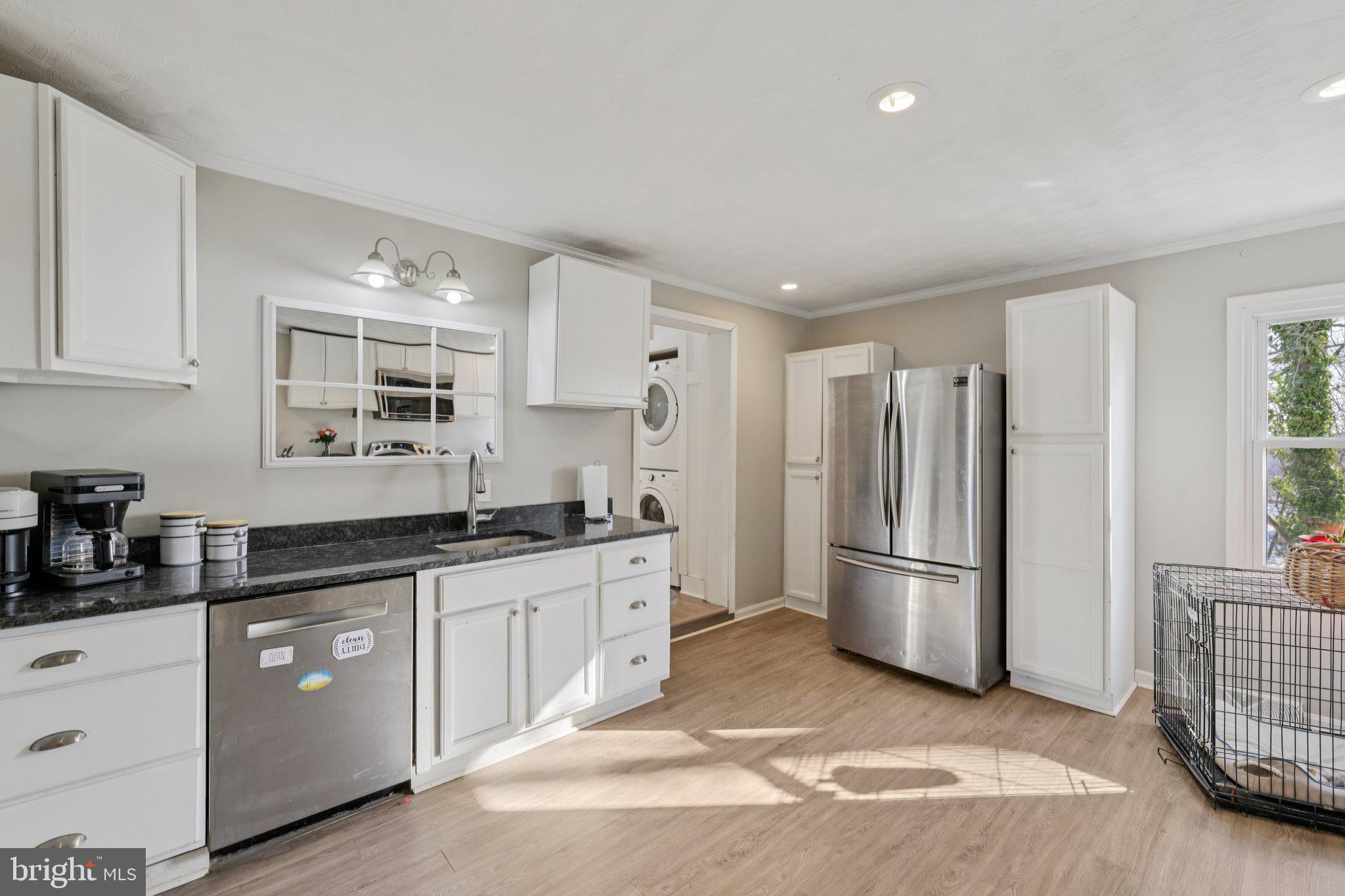 519 North Maple Avenue Brunswick, MD 21716 - Photo 9 of 26 a kitchen with granite countertop a refrigerator and a stove top oven
