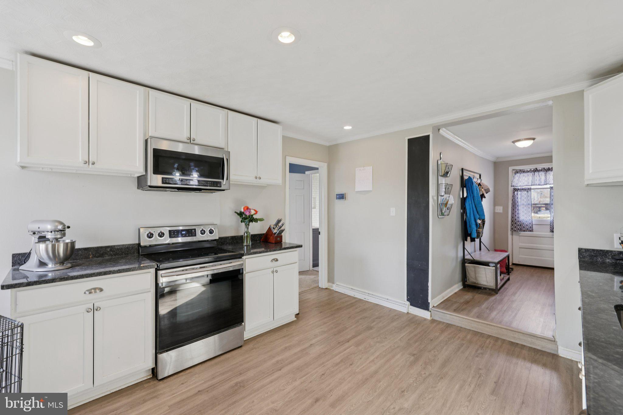 519 North Maple Avenue Brunswick, MD 21716 - Photo 10 of 26 a kitchen with a sink a stove and cabinets
