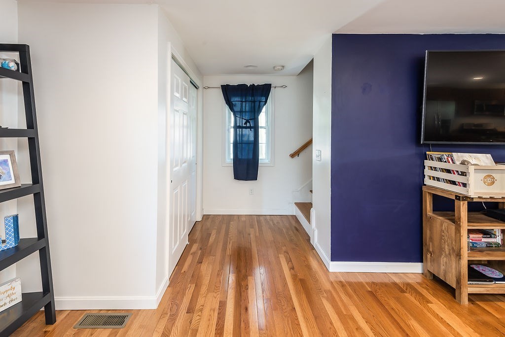 34 Bourne Avenue, Unit A Attleboro, MA 02703 - Photo 15 of 35 a view of hallway with wooden floor and flat screen tv