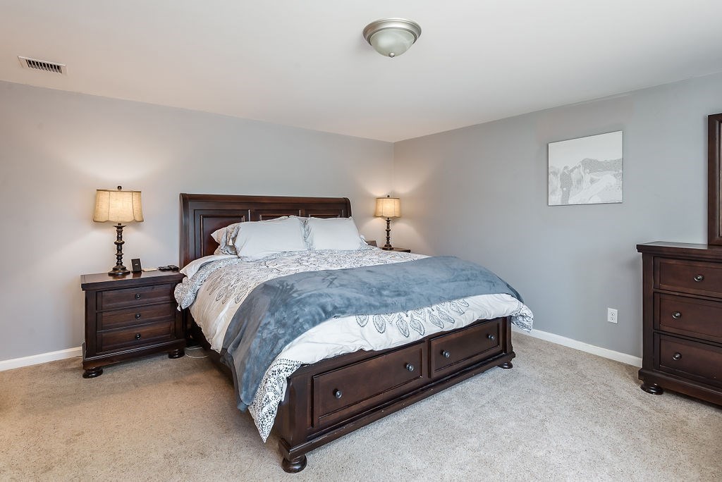 34 Bourne Avenue, Unit A Attleboro, MA 02703 - Photo 17 of 35 a bed sitting in a bedroom and lamp