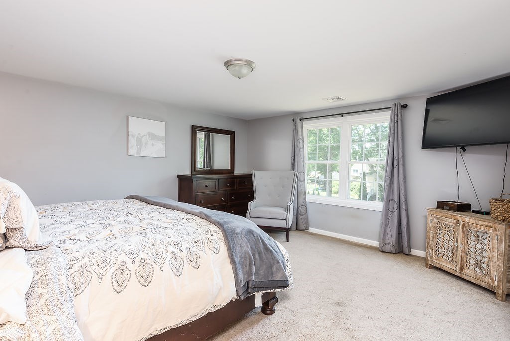 34 Bourne Avenue, Unit A Attleboro, MA 02703 - Photo 18 of 35 a bedroom with a bed flat screen tv and window