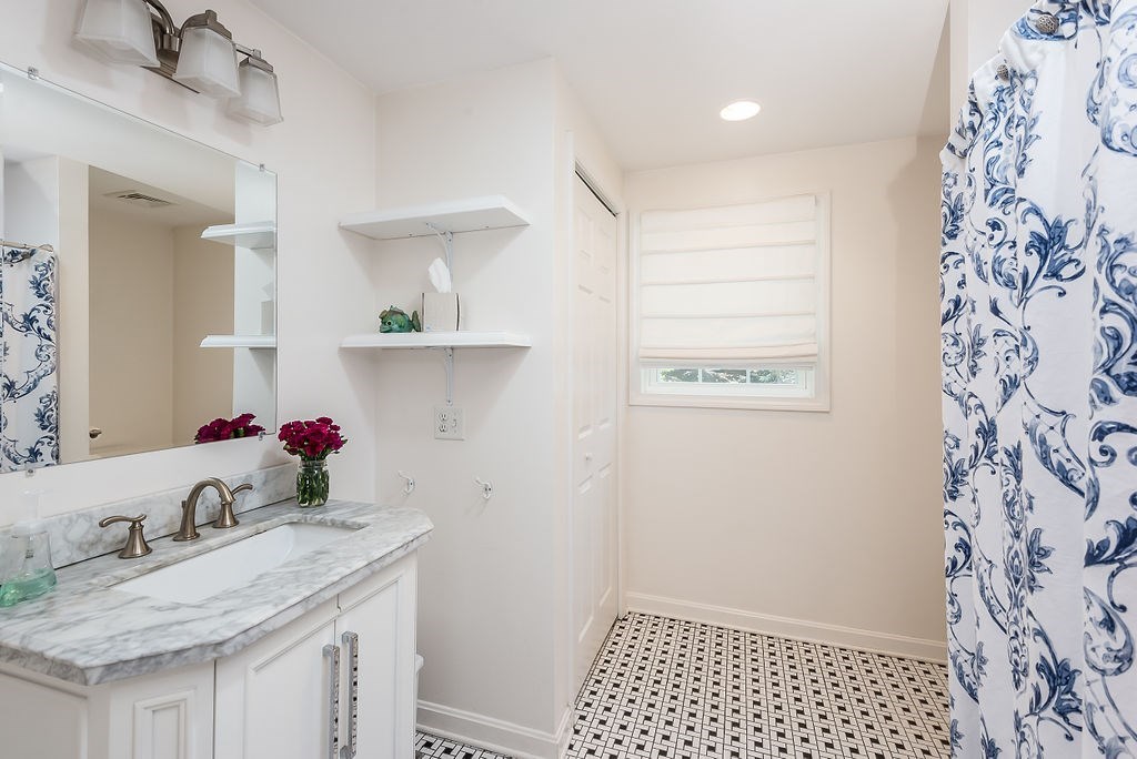 34 Bourne Avenue, Unit A Attleboro, MA 02703 - Photo 20 of 35 a bathroom with a sink and a mirror
