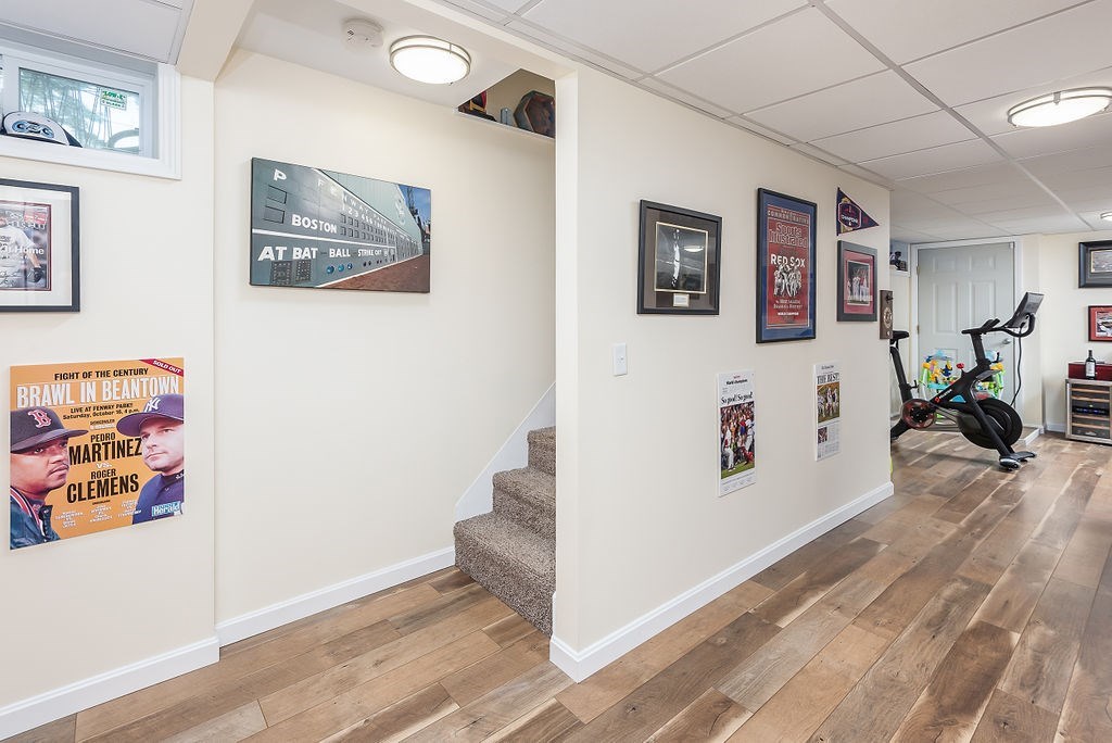 34 Bourne Avenue, Unit A Attleboro, MA 02703 - Photo 25 of 35 a view of a hallway with painting on the wall and wooden floor