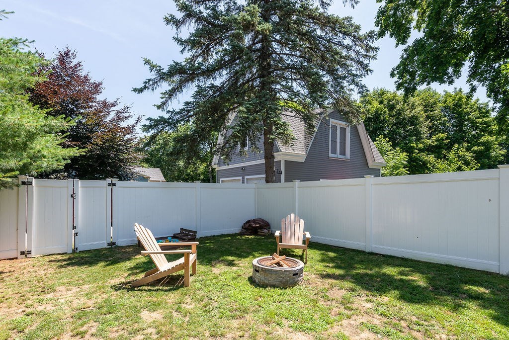 34 Bourne Avenue, Unit A Attleboro, MA 02703 - Photo 32 of 35 a backyard of a house with table and chairs