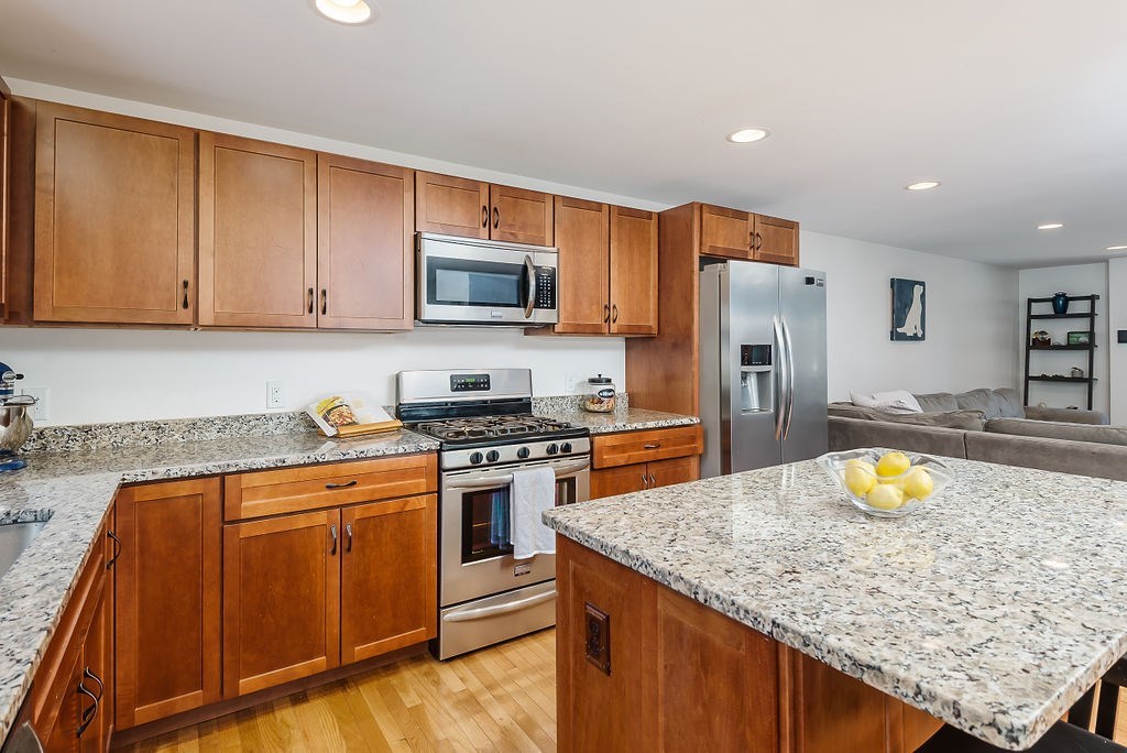 34 Bourne Avenue, Unit A Attleboro, MA 02703 - Photo 7 of 35 a kitchen with stainless steel appliances granite countertop a stove a sink a refrigerator and a microwave