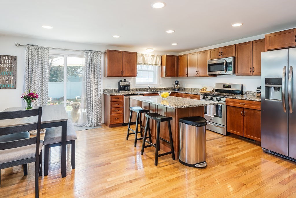 34 Bourne Avenue, Unit A Attleboro, MA 02703 - Photo 9 of 35 a kitchen with stainless steel appliances granite countertop a stove top oven a sink a counter top space and cabinets