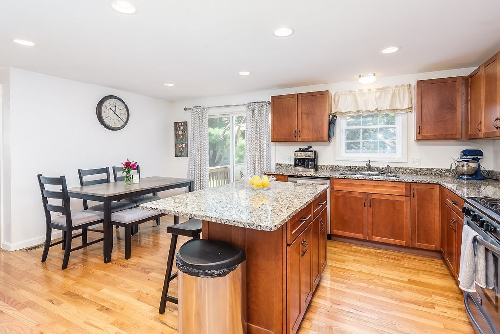 34 Bourne Avenue, Unit A Attleboro, MA 02703 - Photo 10 of 35 a kitchen with granite countertop a table chairs a sink dishwasher window and cabinets