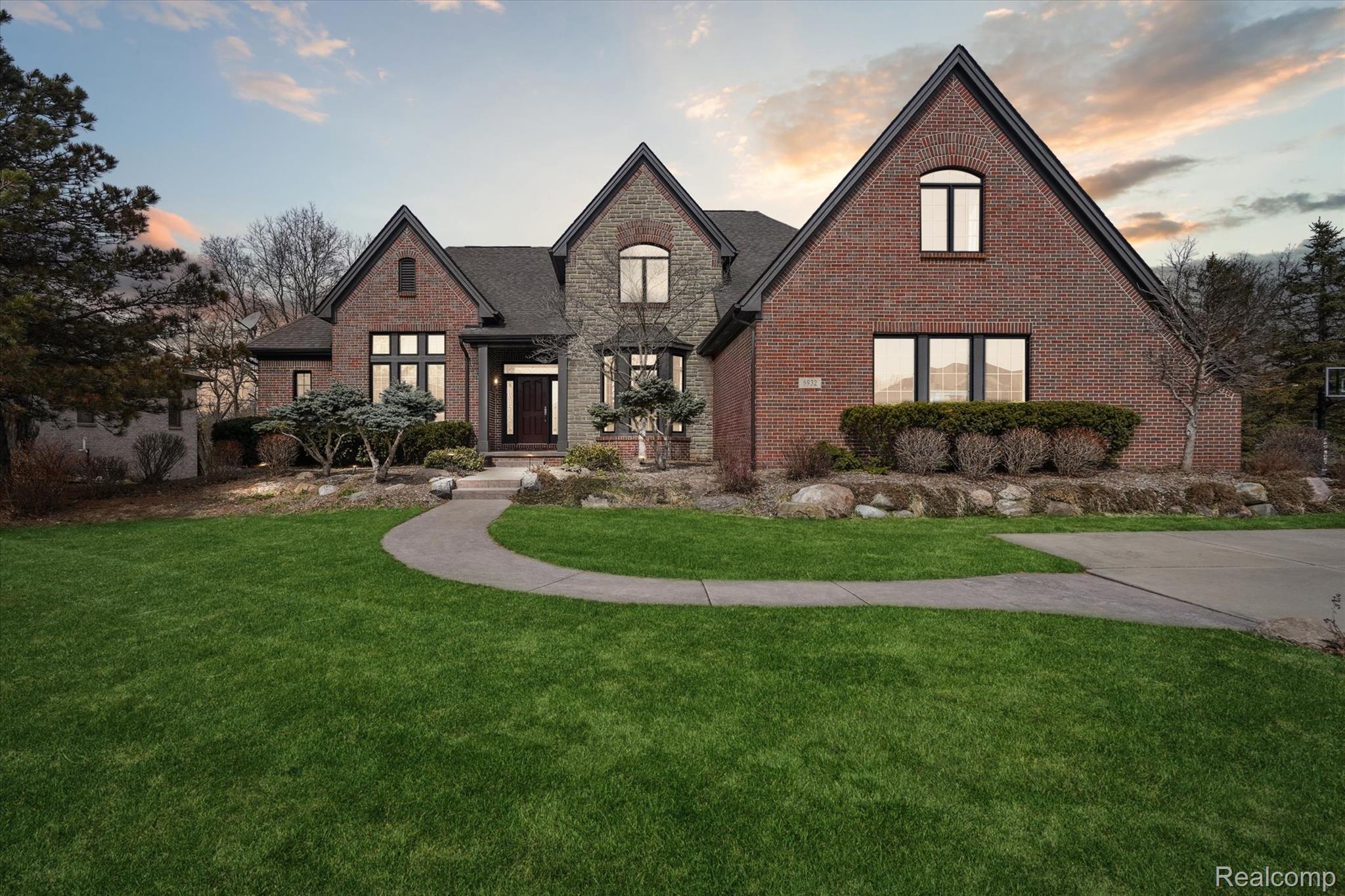6932 Oakhurst Ridge Road Clarkston, MI 48348 - Photo 2 of 78 French provincial home featuring brick siding, a front lawn, and stone siding