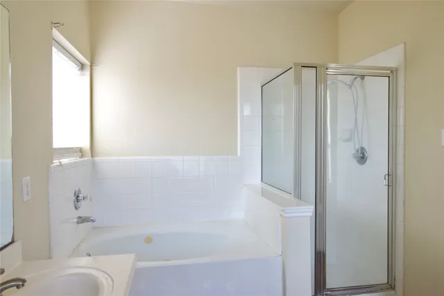a bathroom with a bathtub and a shower