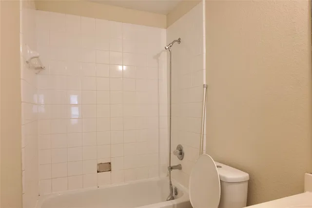a bathroom with a bathtub and a toilet