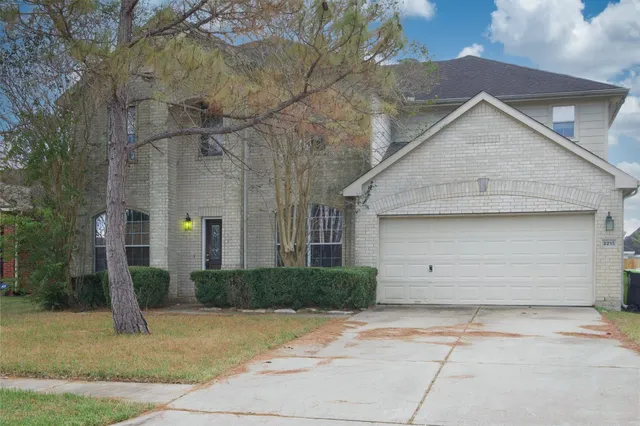 a view of a house with a yard and garage