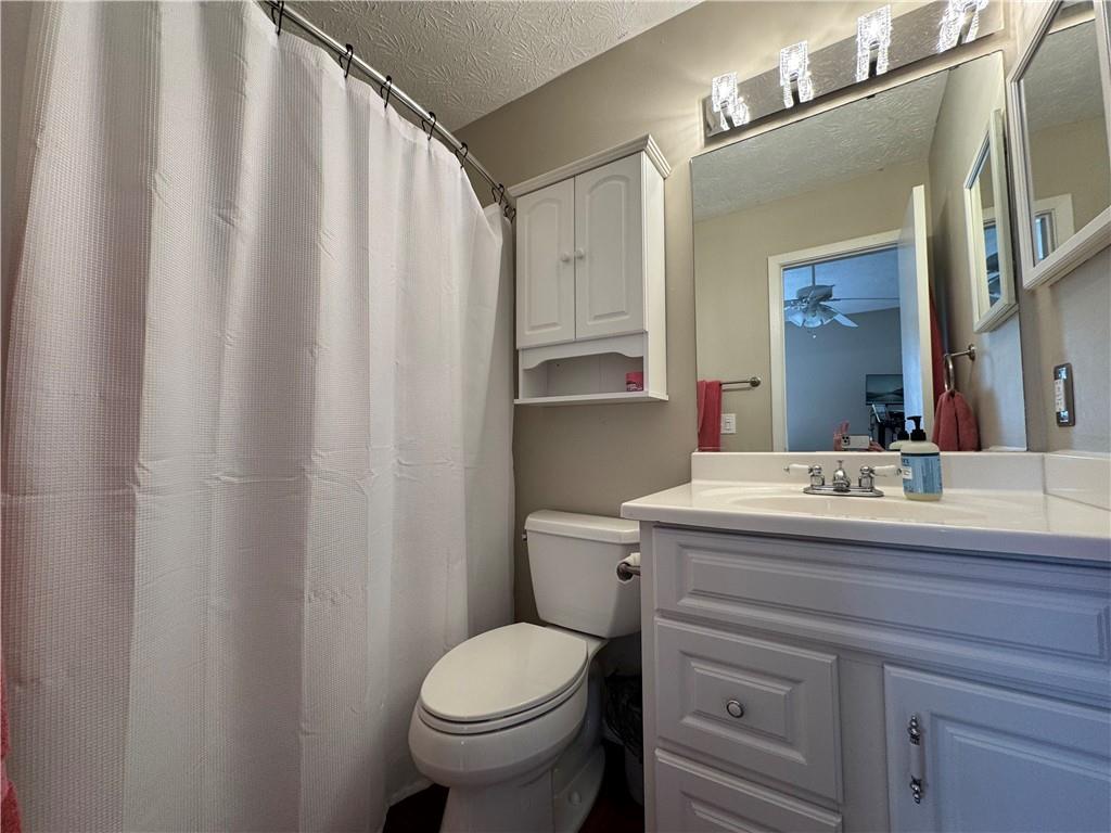 2104 Queen Anne Court Sandy Springs, GA 30350 - Photo 12 of 29 a bathroom with a granite countertop sink toilet and mirror