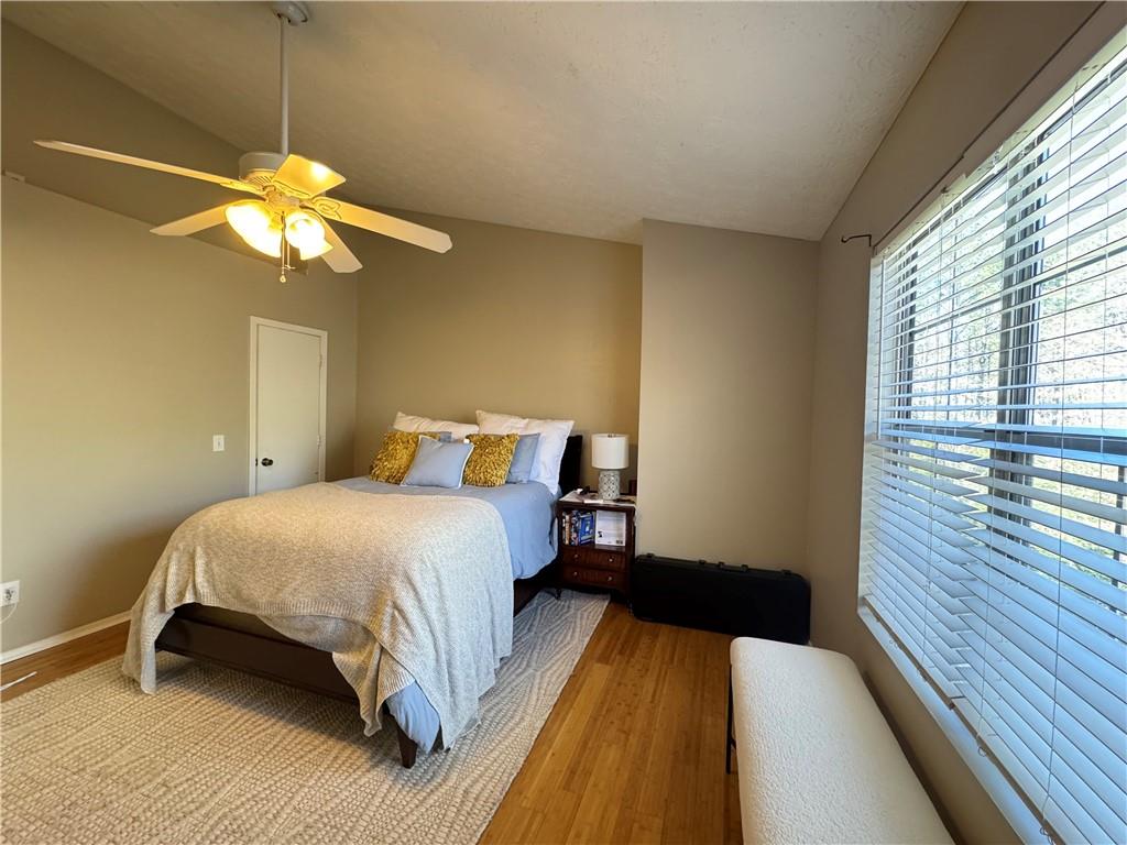 2104 Queen Anne Court Sandy Springs, GA 30350 - Photo 15 of 29 a bedroom with a bed and a chandelier