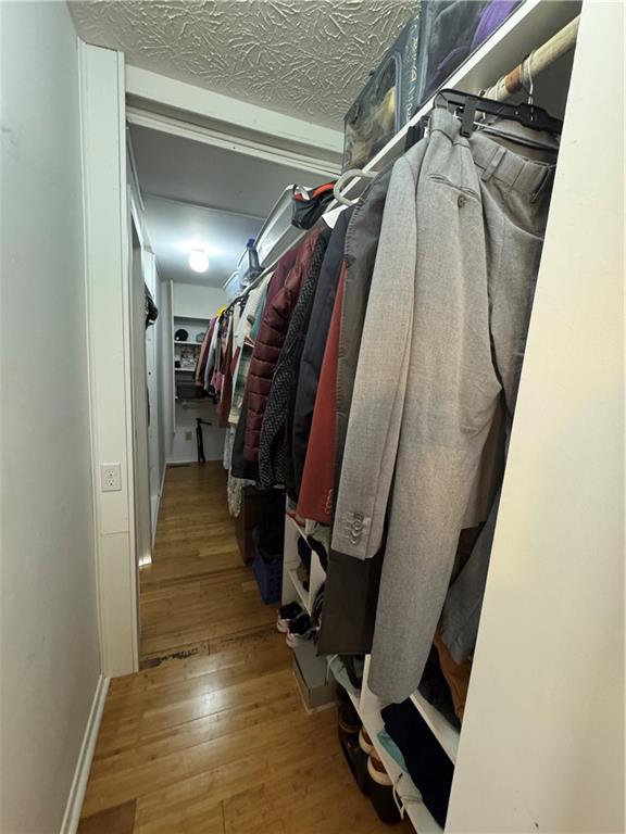 2104 Queen Anne Court Sandy Springs, GA 30350 - Photo 16 of 29 a view of walk in closet with clothes and shoes