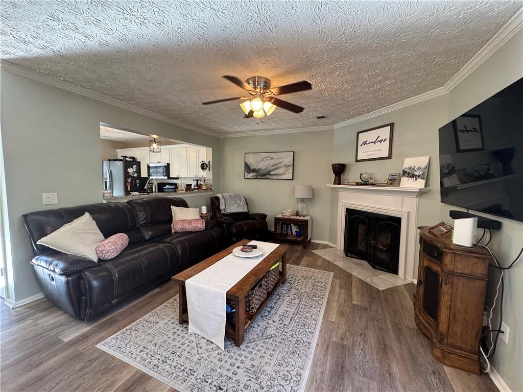 2104 Queen Anne Court Sandy Springs, GA 30350 - Photo 10 of 29 a living room with furniture a fireplace and a flat screen tv