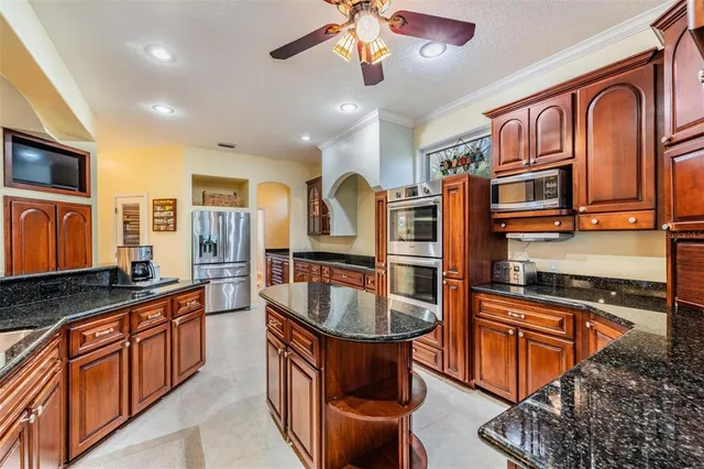 a dining room with furniture a flat screen tv and a large window