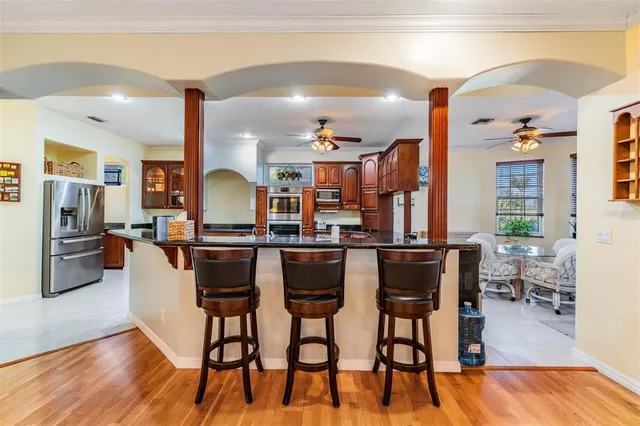 a dining room with furniture a chandelier and wooden floor